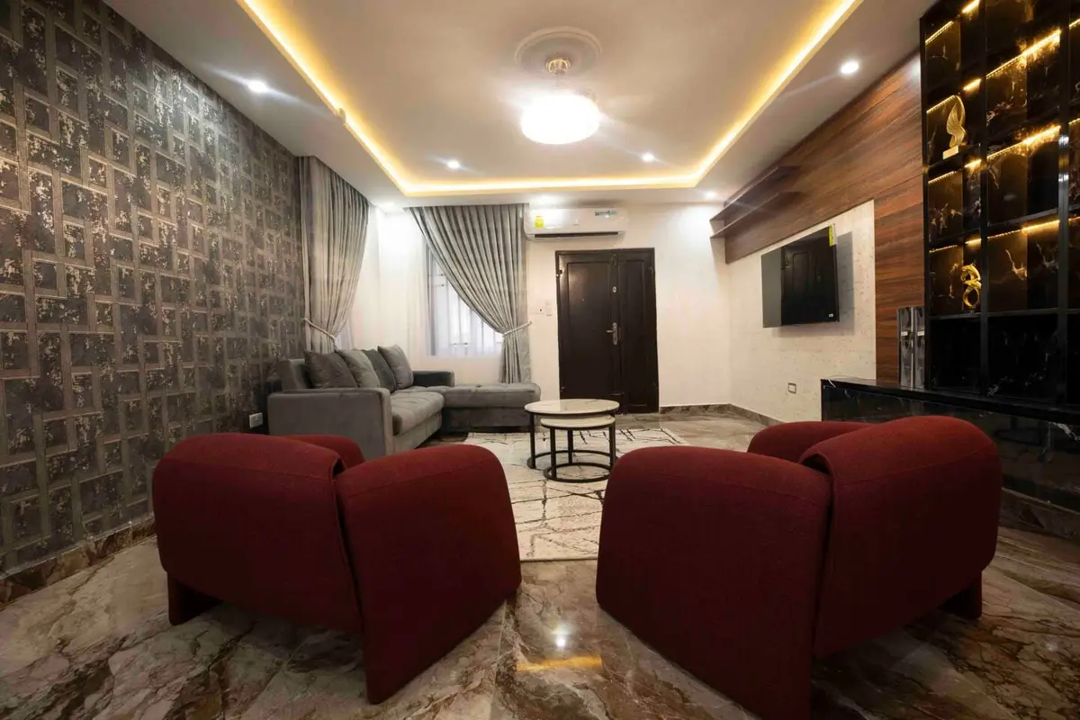 Living room with backlit display shelving and wall-mounted TV