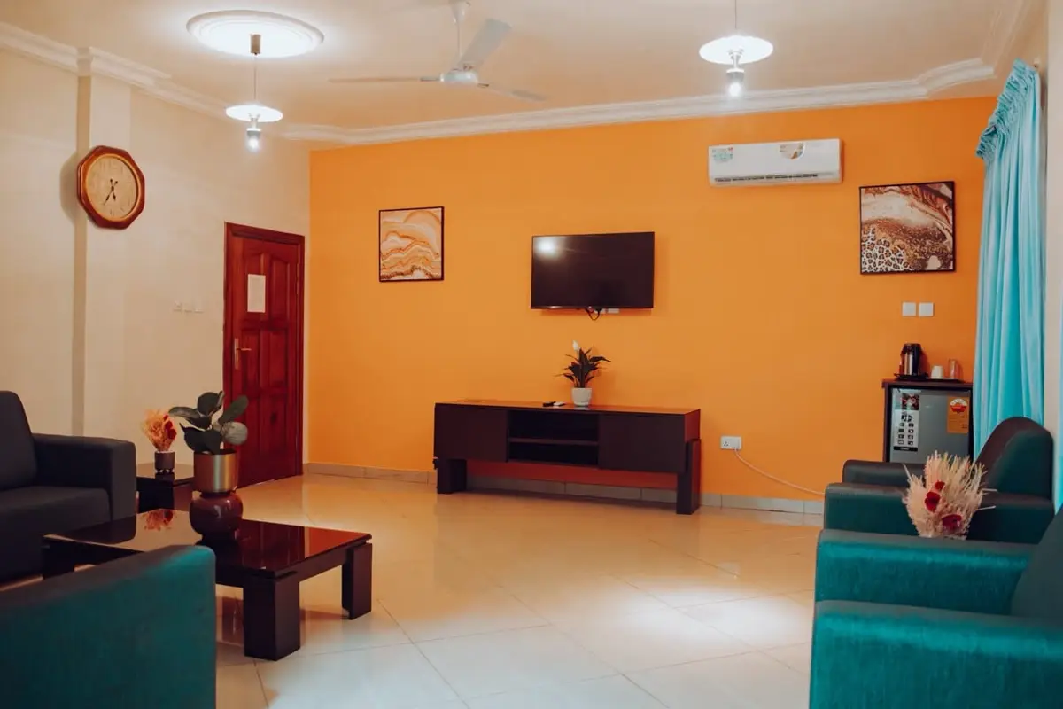 Suite sitting room with orange feature wall and TV